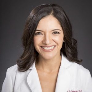 Dr. Vanessa Calderón, MD MPP, a life coach with curly brown hair, big smile, and wearing a white doctor's coat, radiates warmth and expertise.