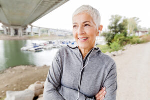 Smiling Senior Woman Relax Listening Music With Earphones After Running, Gray-Short Hair, Wear Sports clothes ,Workout Outdoor.